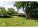Spacious backyard featuring lush greenery and a storage shed, perfect for outdoor enjoyment at 6040 Manker St, Indianapolis, IN 46227