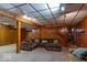 Finished basement with carpeting, wood paneling, and stairs to upper level at 6040 Manker St, Indianapolis, IN 46227