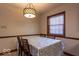 Dining area featuring a table with floral patterned cover and a modern light fixture at 6040 Manker St, Indianapolis, IN 46227
