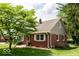 Well-maintained brick home with mature trees and landscaped grounds at 6040 Manker St, Indianapolis, IN 46227