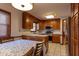 Kitchen with dining table; featuring wood cabinetry and stainless steel appliances at 6040 Manker St, Indianapolis, IN 46227