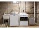 Basement laundry area featuring a utility sink, washer and dryer at 6040 Manker St, Indianapolis, IN 46227