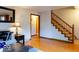 Bright living room with hardwood floors and staircase at 6040 Manker St, Indianapolis, IN 46227
