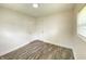 Cozy bedroom featuring wood-look flooring, white walls, and a bright window at 6150 E 25Th St, Indianapolis, IN 46219