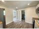 Open kitchen featuring stainless appliances, white cabinets, built-in shelving and wood look flooring at 6150 E 25Th St, Indianapolis, IN 46219