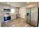 Modern kitchen features stainless steel appliances, grey cabinets, wood countertops, and wood flooring at 6150 E 25Th St, Indianapolis, IN 46219