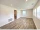 Large living room featuring wood look flooring, recessed lighting, and bright windows at 6150 E 25Th St, Indianapolis, IN 46219