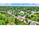 Beautiful aerial view of a home in a lush neighborhood with mature trees and a pond at 6609 Fountain Springs Blvd, Indianapolis, IN 46236