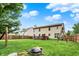 Expansive backyard featuring a wooden deck, mature trees, swing set, hammock and a fire pit perfect for outdoor entertaining at 6609 Fountain Springs Blvd, Indianapolis, IN 46236