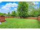 Large, well-maintained backyard showcasing a deck and ample green space for outdoor enjoyment at 6609 Fountain Springs Blvd, Indianapolis, IN 46236