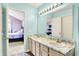 Bathroom with double sinks, marble countertop and view of bedroom at 6609 Fountain Springs Blvd, Indianapolis, IN 46236