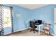 Bright bedroom with a dedicated workspace, highlighted by natural light and a comfortable seating area at 6609 Fountain Springs Blvd, Indianapolis, IN 46236