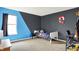 Modern bedroom with gray and blue walls, featuring sleek furnishings, a comfortable bed and study area at 6609 Fountain Springs Blvd, Indianapolis, IN 46236
