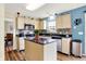 Well-lit kitchen with an island, stainless steel appliances, and modern backsplash at 6609 Fountain Springs Blvd, Indianapolis, IN 46236