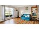 Cozy living room with hardwood floors, large window, and comfortable blue couch at 6609 Fountain Springs Blvd, Indianapolis, IN 46236