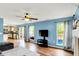 Spacious open concept living room with hardwood floors, a kitchen view, and a TV at 6609 Fountain Springs Blvd, Indianapolis, IN 46236