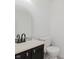 Powder room with a single vanity, an ornate mirror, and a toilet at 6703 Wimbledon Dr, Zionsville, IN 46077