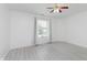 Bright bedroom features neutral walls, modern ceiling fan, and window letting in natural light at 6703 Wimbledon Dr, Zionsville, IN 46077