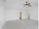 Spacious primary bedroom with ceiling fan, neutral walls, and doors leading to bathroom and closet at 6703 Wimbledon Dr, Zionsville, IN 46077