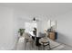 Dining area featuring modern black table, beige chairs, and decorative sideboard at 6703 Wimbledon Dr, Zionsville, IN 46077