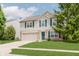 Lovely two-story home with a well-manicured lawn, mature trees, and a charming facade at 6703 Wimbledon Dr, Zionsville, IN 46077