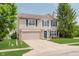Inviting two-story home with blue shutters, a well-maintained lawn, and a brick-accented facade at 6703 Wimbledon Dr, Zionsville, IN 46077