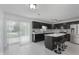 Stylish kitchen featuring black cabinets, stainless steel appliances, and an island with bar stools at 6703 Wimbledon Dr, Zionsville, IN 46077
