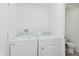 Functional laundry area with white appliances, including a washing machine and a dryer at 6703 Wimbledon Dr, Zionsville, IN 46077