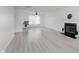 Bright living room with modern floors, a cozy fireplace, and a ceiling fan for added comfort at 6703 Wimbledon Dr, Zionsville, IN 46077
