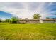 Spacious backyard with a well-manicured lawn and a charming home exterior, perfect for outdoor activities at 6863 W Jennifer Ct, Greenfield, IN 46140