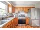 Well-appointed kitchen with modern appliances, natural lighting, and wooden cabinets at 6863 W Jennifer Ct, Greenfield, IN 46140