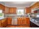 Cozy kitchen featuring stainless steel appliances, natural light, and wood cabinets at 6863 W Jennifer Ct, Greenfield, IN 46140