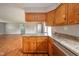 Open kitchen with stainless steel appliances, wood cabinets, and eat-in bar at 6863 W Jennifer Ct, Greenfield, IN 46140