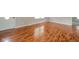 Bright living room with shiny hardwood floors and a freshly painted door at 6863 W Jennifer Ct, Greenfield, IN 46140