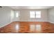 Well-lit room featuring a big door, fresh paint, and shiny hardwood floors at 6863 W Jennifer Ct, Greenfield, IN 46140