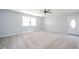Spacious living room with neutral paint, large windows, and modern ceiling fan at 6863 W Jennifer Ct, Greenfield, IN 46140