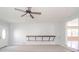 Bright and spacious living room with modern ceiling fan and view of the kitchen at 6863 W Jennifer Ct, Greenfield, IN 46140