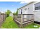 Back of house featuring small porch and door, and surrounded by lush landscaping and wooden fence at 703 Kappes St, Indianapolis, IN 46221