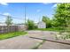 A backyard featuring a storage shed, wooden fence, and concrete patio area at 703 Kappes St, Indianapolis, IN 46221