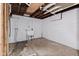 Utility area in unfinished basement features a utility sink and plumbing for future use at 703 Kappes St, Indianapolis, IN 46221