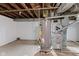 Unfinished basement with painted block walls, open ceiling, and utility equipment at 703 Kappes St, Indianapolis, IN 46221