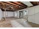 Unfinished basement with exposed beams and painted walls, offering potential for customization at 703 Kappes St, Indianapolis, IN 46221