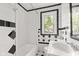 Classic black and white tiled bathroom with updated fixtures and bright natural light at 703 Kappes St, Indianapolis, IN 46221