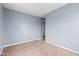 Bedroom with neutral carpet, light blue walls and door that leads to another room at 703 Kappes St, Indianapolis, IN 46221