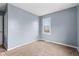 Bedroom with neutral carpet, light blue walls and one window with natural light at 703 Kappes St, Indianapolis, IN 46221