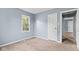 Bedroom with neutral carpet, light blue walls and a door leading to the hallway at 703 Kappes St, Indianapolis, IN 46221