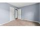Bedroom with neutral carpet, light blue walls and two doors leading to other rooms at 703 Kappes St, Indianapolis, IN 46221