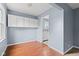 Bright dining room featuring hardwood floors, updated cabinets, and a fresh coat of paint at 703 Kappes St, Indianapolis, IN 46221
