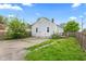 Shows back exterior with patio, and small porch, surrounded by landscaping and wooden fence at 703 Kappes St, Indianapolis, IN 46221