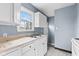 Classic kitchen featuring bright window, crisp cabinetry, ample counter space and fresh paint at 703 Kappes St, Indianapolis, IN 46221